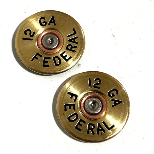 2 round gold brass 12 gauge shotgun shell slices with black stamped lettering reading 12 GA FEDERAL on a gray background