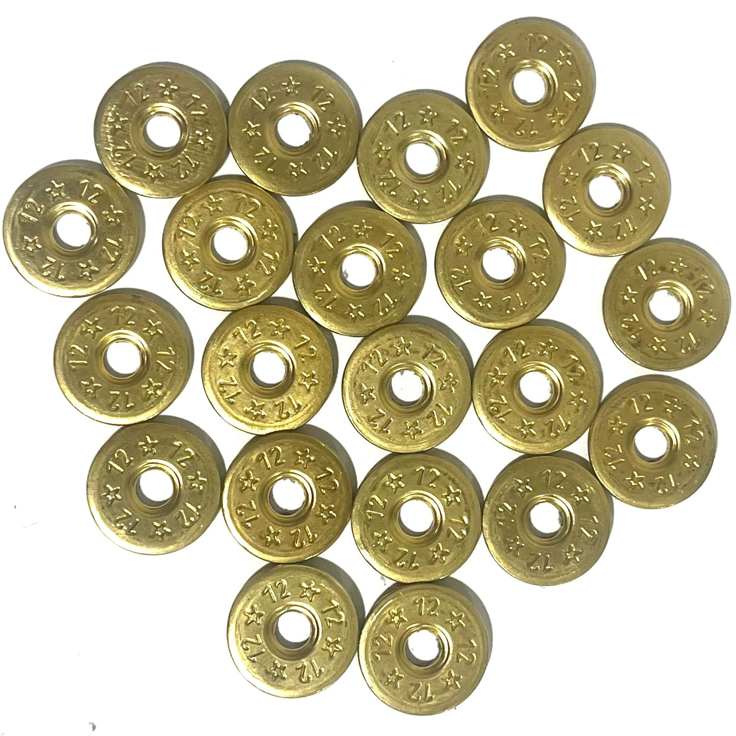 A grid of 20 deprimed 12 gauge brass shotgun shell slices with 12 and star stamped designs and open center holes on white background