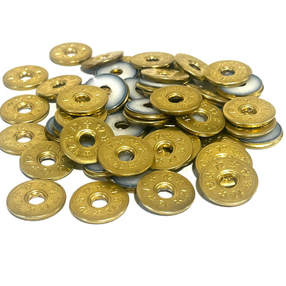A pile of deprimed 12 gauge brass shotgun shell slices with 12 and star stamped designs and open center holes