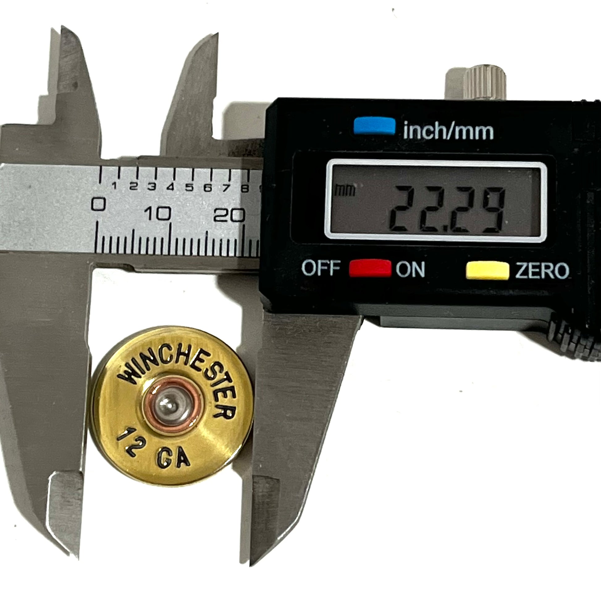 Digital caliper measuring the diameter of a gold Winchester 12 GA shotgun shell slice at 22.29 mm