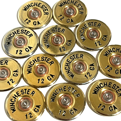 12 gold Winchester 12 GA shotgun shell slices with black lettering arranged in a cluster on a white background