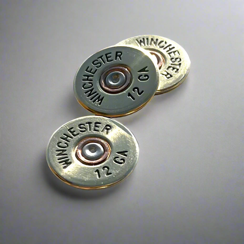 3 gold Winchester 12 GA shotgun shell slices on a gray gradient background