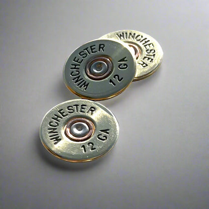 3 gold Winchester 12 GA shotgun shell slices on a gray gradient background