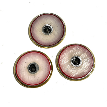 3 hand-painted shotgun shell slices with cream and red rims and black centers, close-up