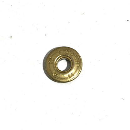 Close-up of a gold brass Fiocchi 28 gauge shotgun shell slice marked 28