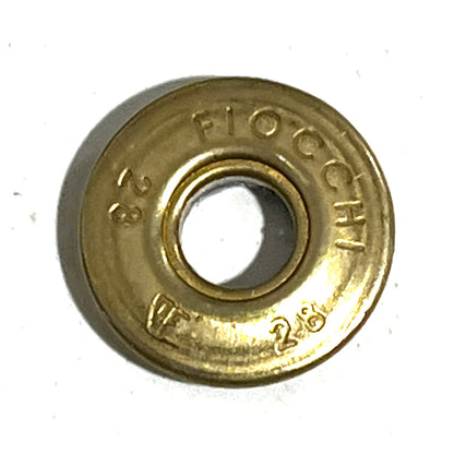 Close-up of a gold brass Fiocchi 28 gauge shotgun shell slice with a deprimed center