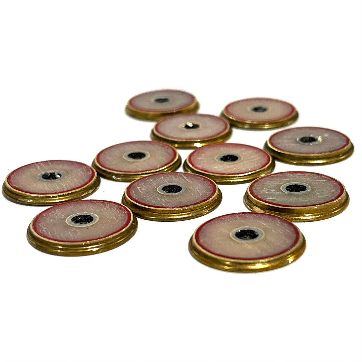 10 gold Winchester 12 gauge shotgun shell slices with cream and red centers arranged in rows