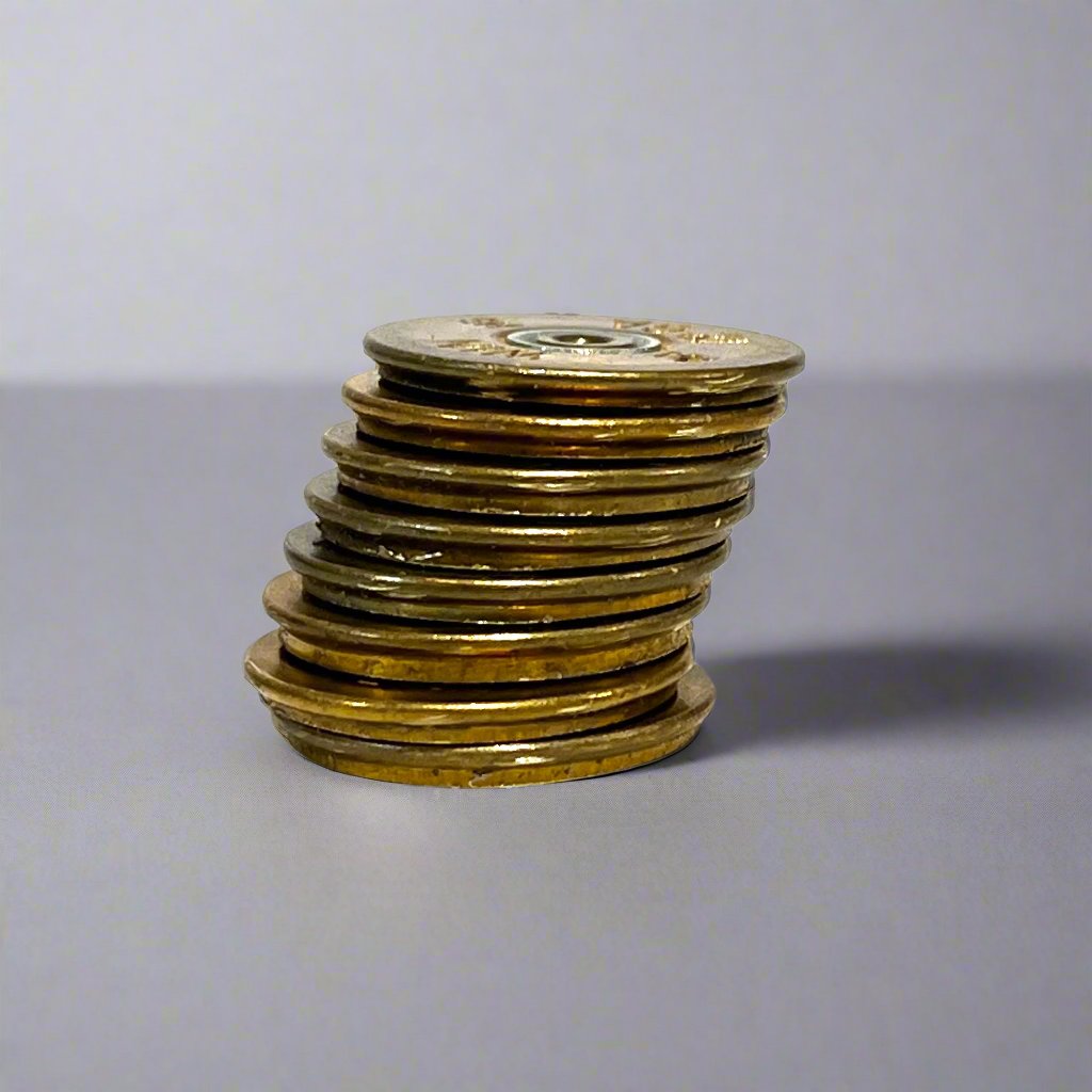 Stack of gold Winchester 12 gauge shotgun shell slices viewed from the side