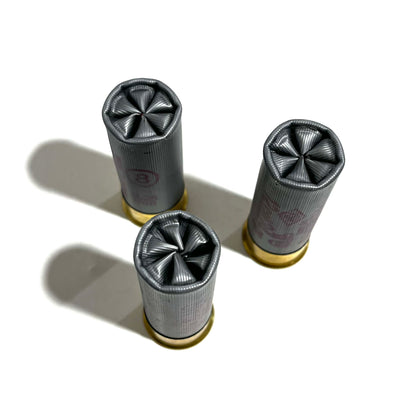 3 gray shotgun shells viewed from above showing crimped star folded open ends