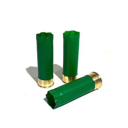 3 empty green 12 gauge shotgun shells with crimped open ends and brass bases on a white background