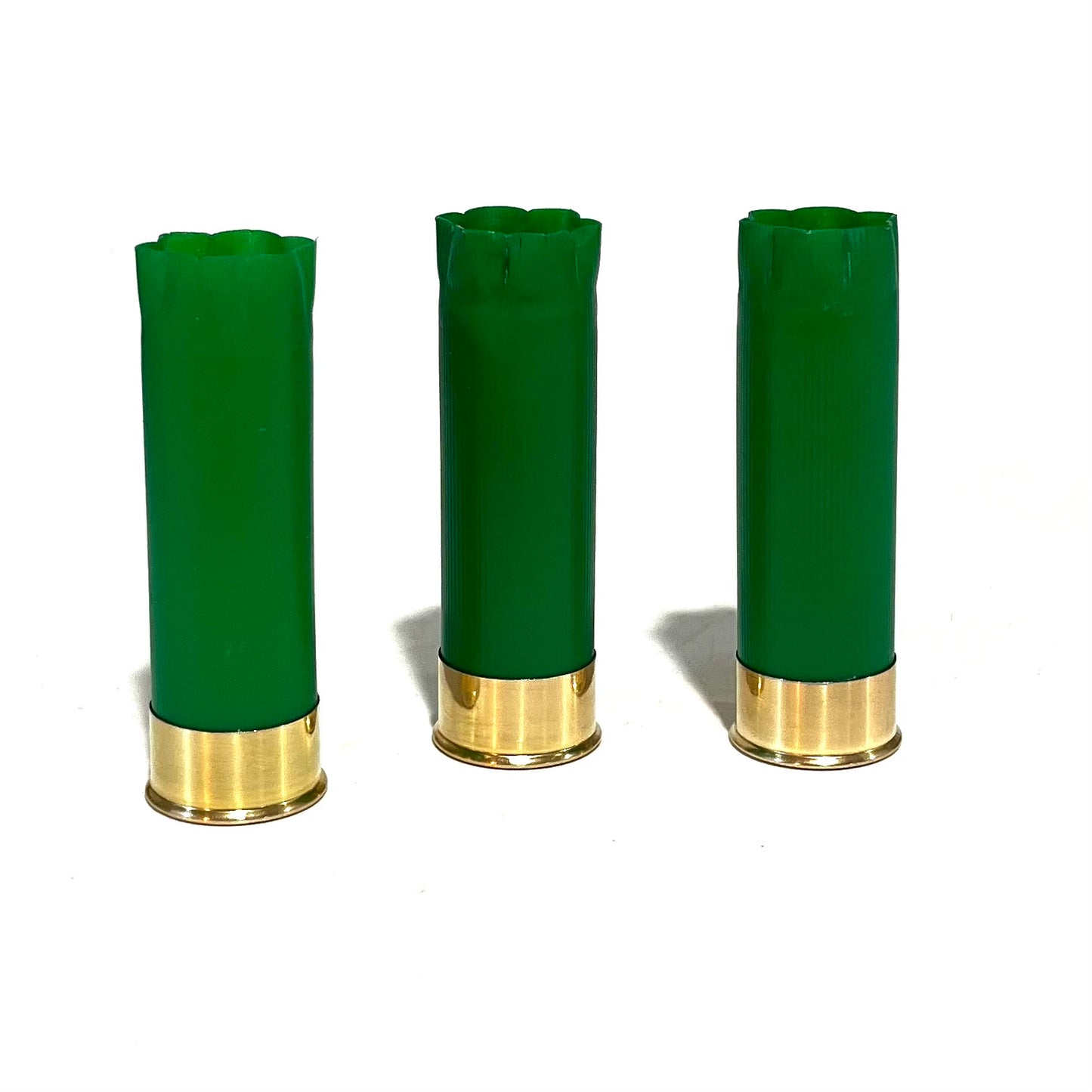 3 empty green 12 gauge shotgun shells with crimped open ends standing upright on a white background