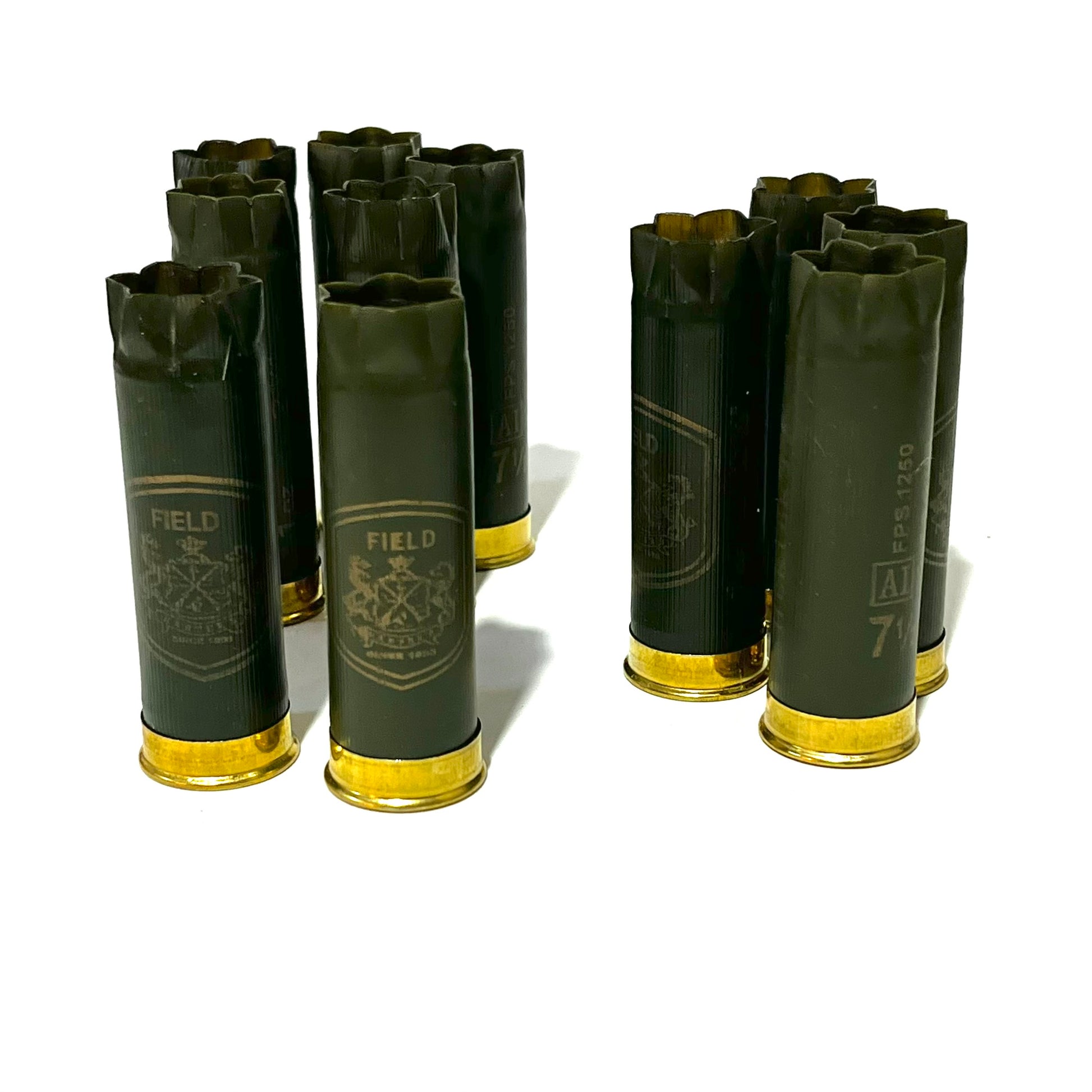 Eight olive green 12 gauge shotgun shells with brass bases standing in two groups, “Field” branding visible on the hulls