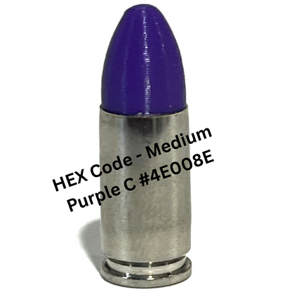 A nickel 9mm Luger dummy round with a purple bullet tip, overlaid with color reference text reading 'HEX Code - Medium Purple C #4E008E'