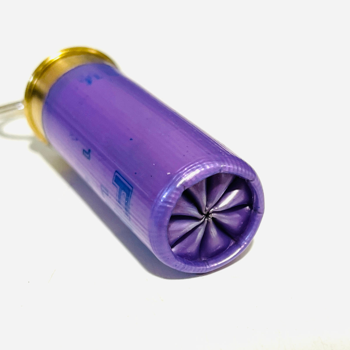 Close-up of the folded 8-point star crimp on an empty lavender Fiocchi shotshell keychain