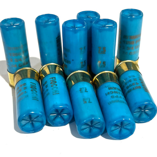 Ten light blue Fiocchi 12 gauge shotgun shell hulls, five standing with closed crimped tops and five lying with open crimped mouths