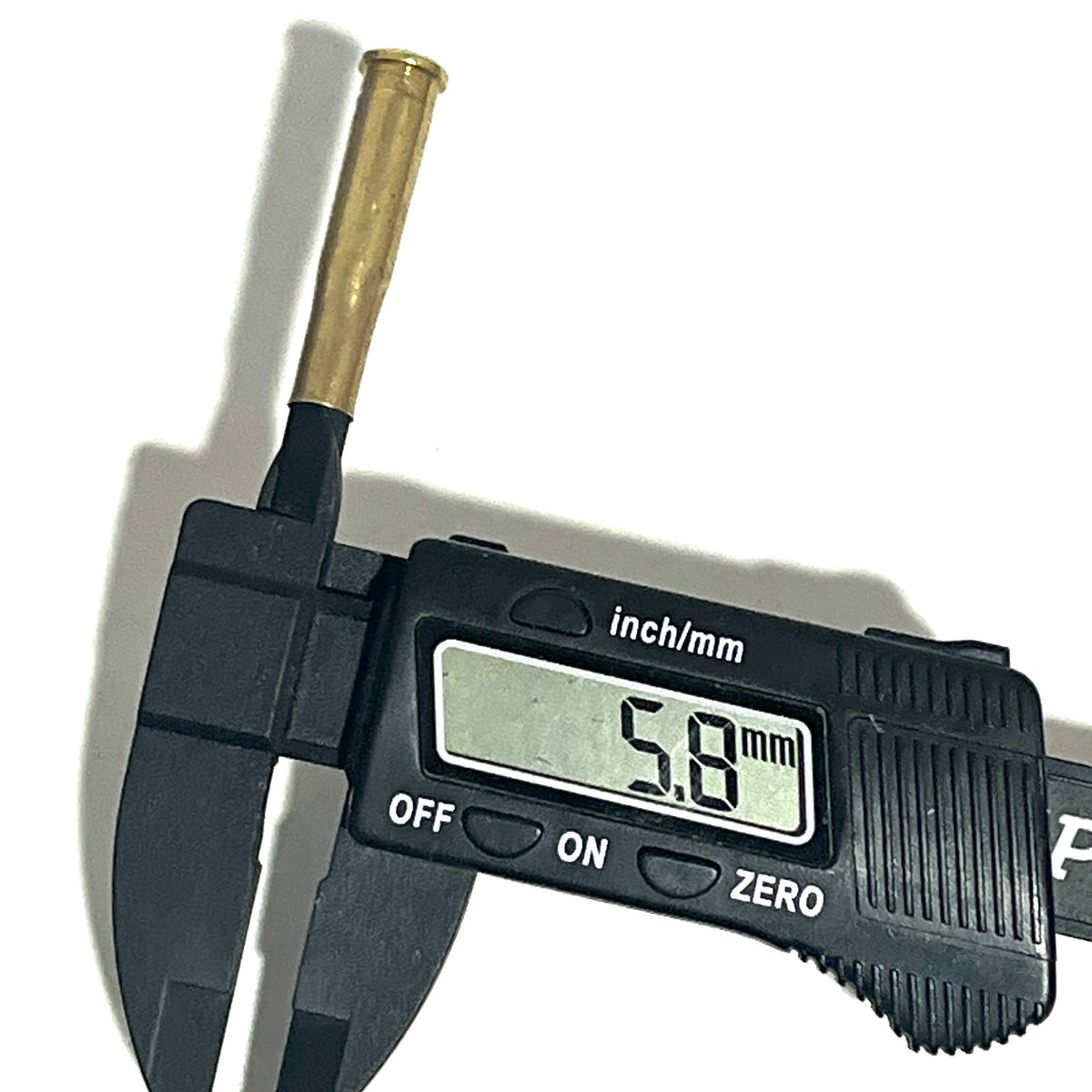 Digital caliper measuring a .22 Hornet brass shell casing at 5.8 mm