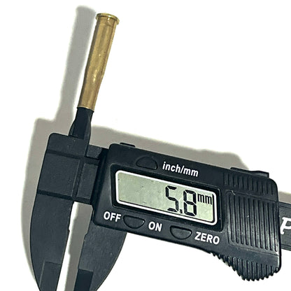 Digital caliper measuring a .22 Hornet brass shell casing at 5.8 mm