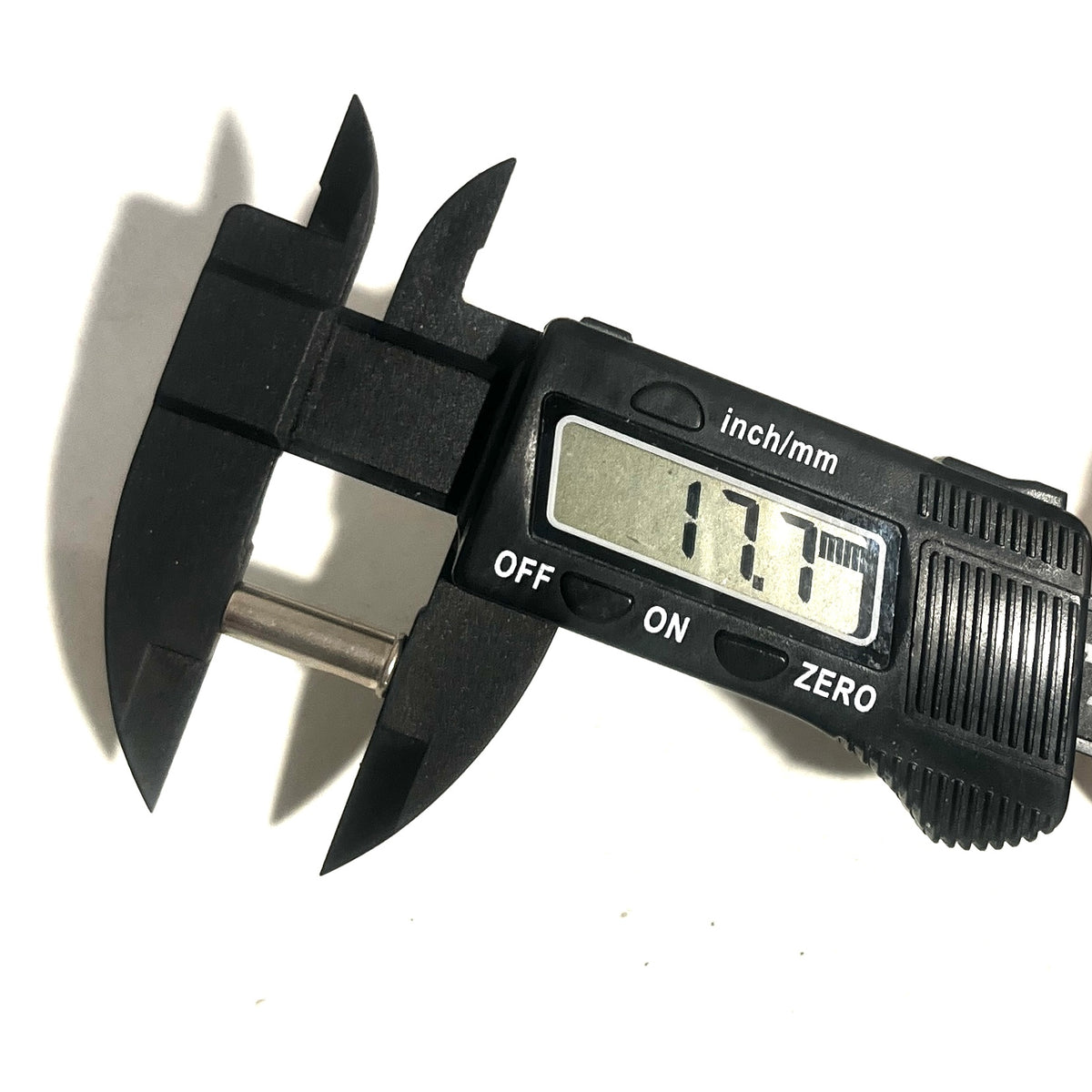 Digital caliper measuring the length of a nickel 22 caliber casing showing 17.7 mm