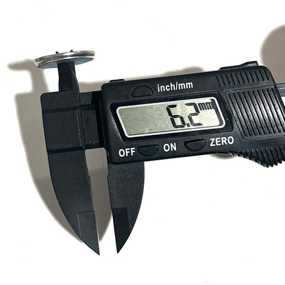A digital caliper measuring the inside diameter of a silver shotgun shell slice on a white background.