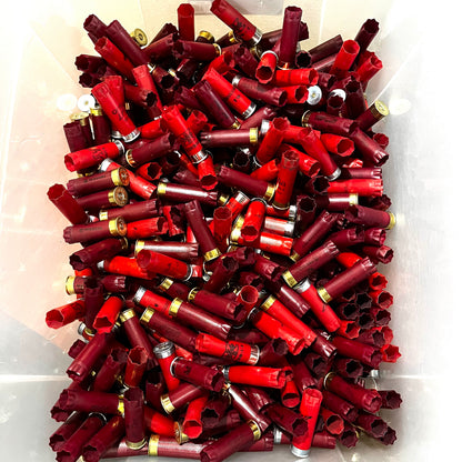 Large bin filled with mixed red and burgundy 12 gauge shotgun shells with gold and silver bases