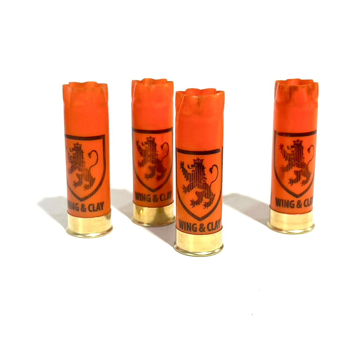 4 orange Monarch Wing & Clay 12 gauge shotgun shells with a lion crest logo, standing upright on a white background