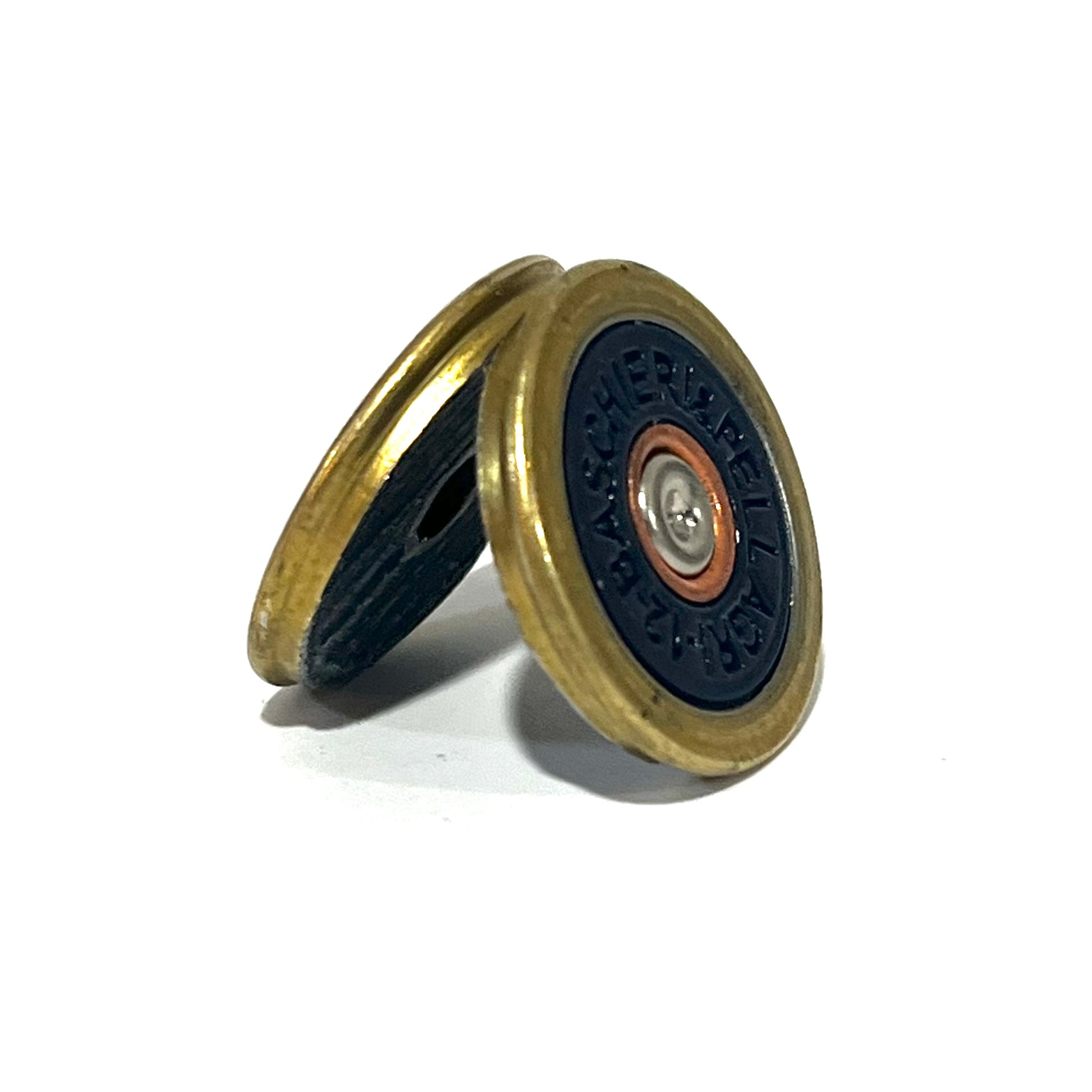 Navy blue Baschieri & Pellagri 12 gauge shotgun shell slice with a brass rim, leaning against another slice
