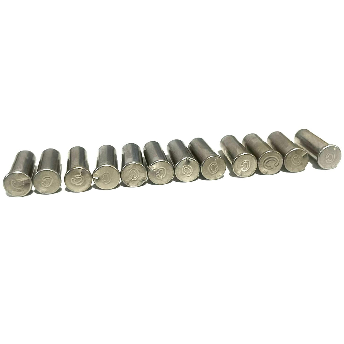 12 nickel 22 caliber empty casings standing in a row showing headstamps on a white background