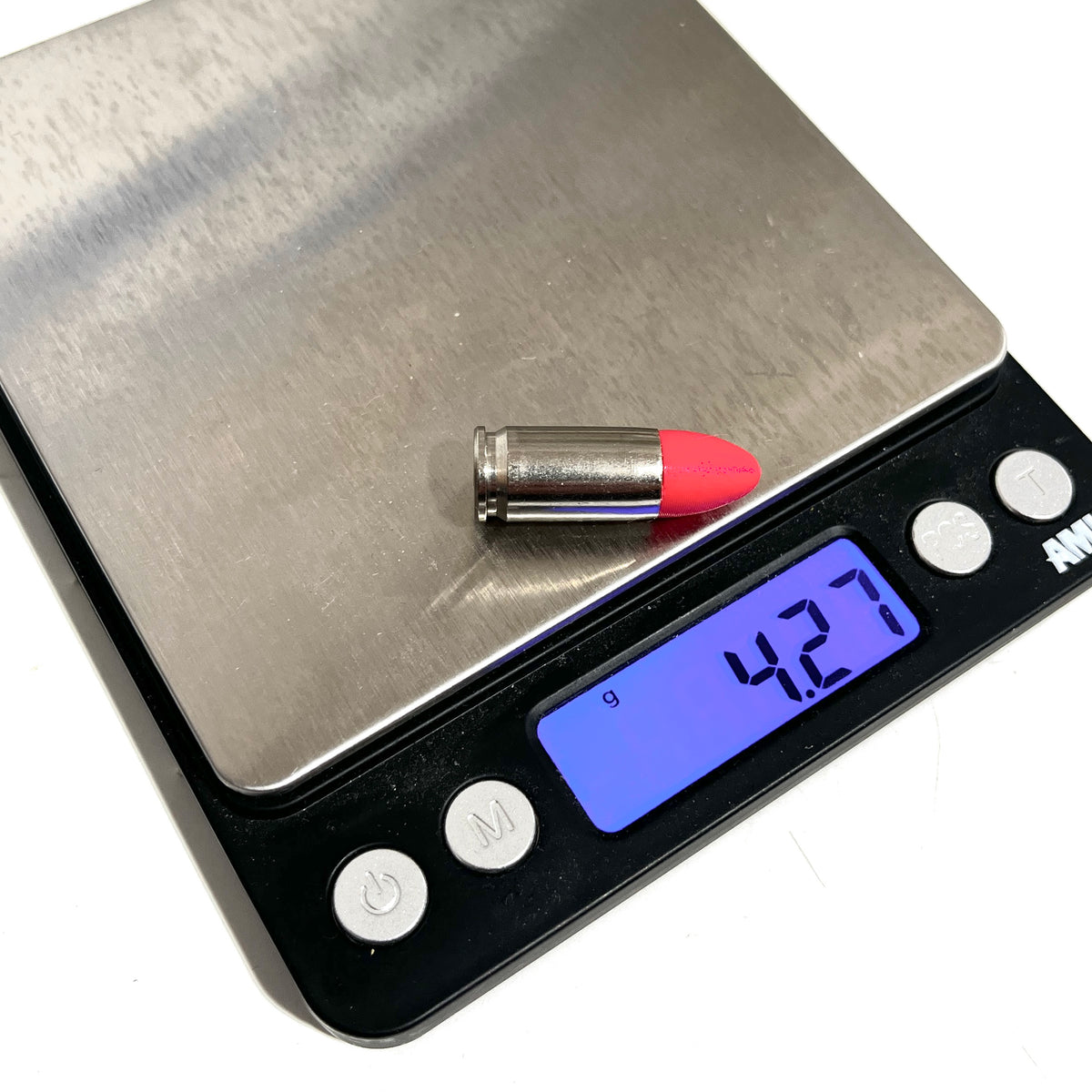 Fake nickel 9mm Luger dummy round with red painted tip on a digital gram scale reading 4.27 grams