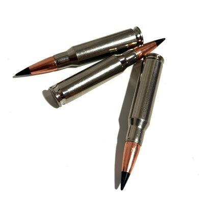 Three nickel .308 cartridges scattered together on a white background with black tips visible