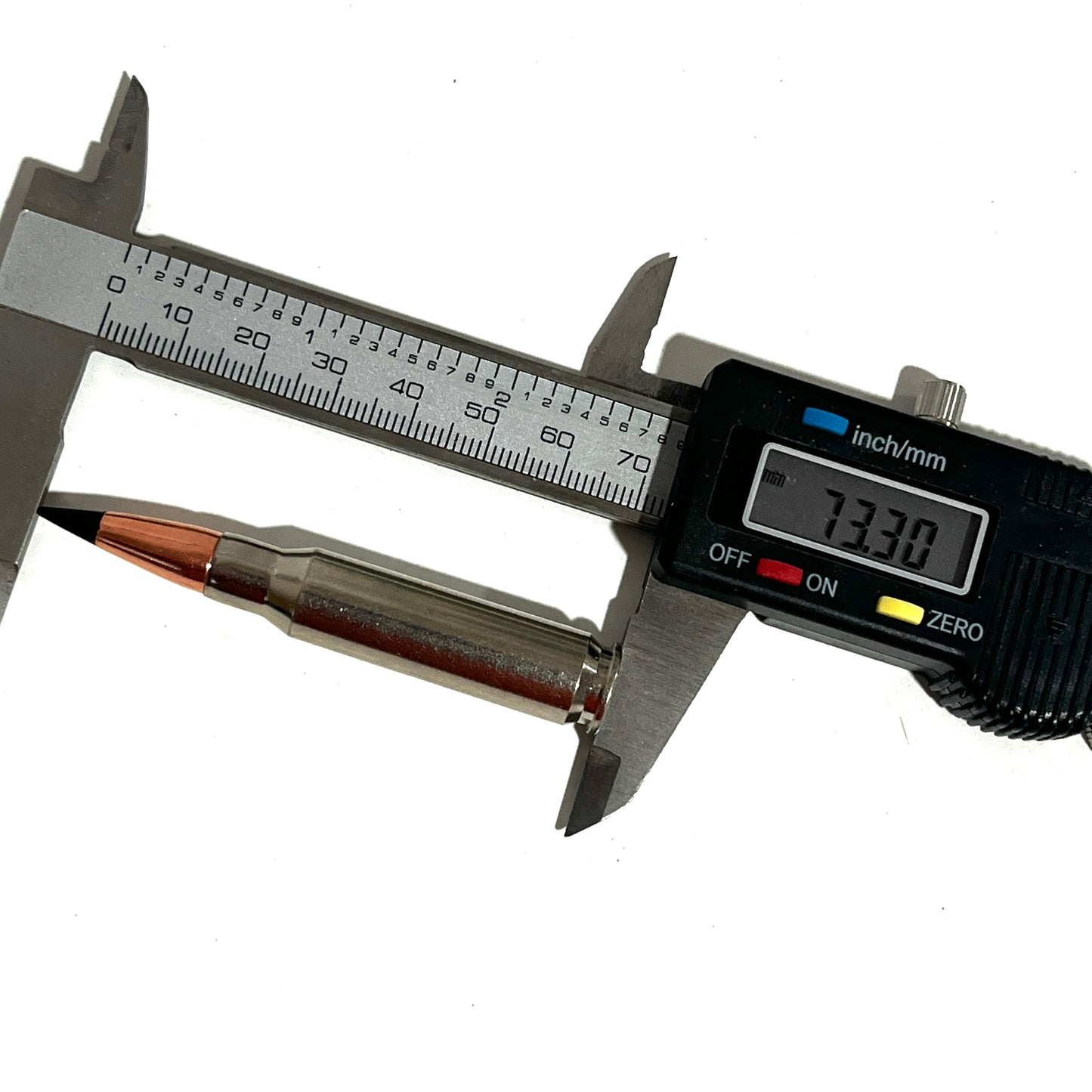 Nickel .308 dummy round measured with a digital caliper reading 73.30 mm in length