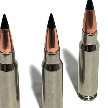 Three nickel .308 dummy rounds at an angle showing case necks and shoulders on a white background
