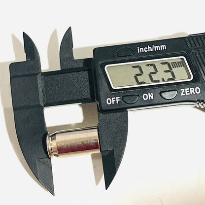 Digital caliper reading 22.3 mm along the full length of an empty nickel 45 ACP casing
