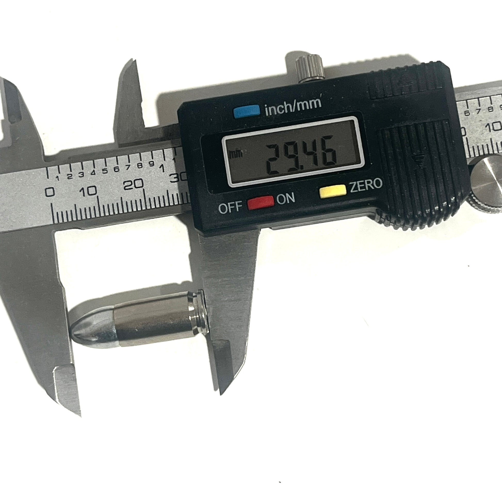 A digital caliper measures the overall length of a nickel 9mm shell at 29.46 mm.