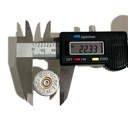 Digital caliper measuring the diameter of a silver Nobel Sport 12 gauge shotgun shell slice at 22.33 mm