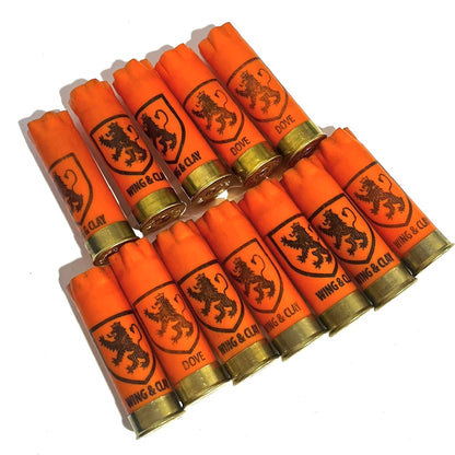 Twelve orange Monarch Wing and Clay 12 gauge shotgun shells with gold bases arranged in rows