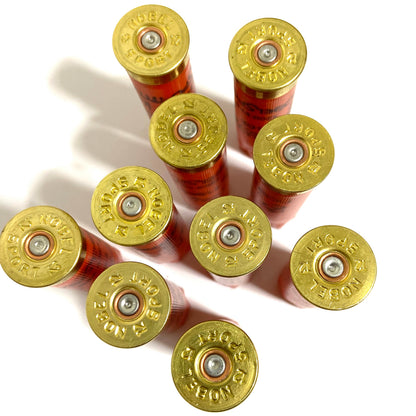 9 orange Nobel Sport shotgun shells viewed from above showing brass headstamps
