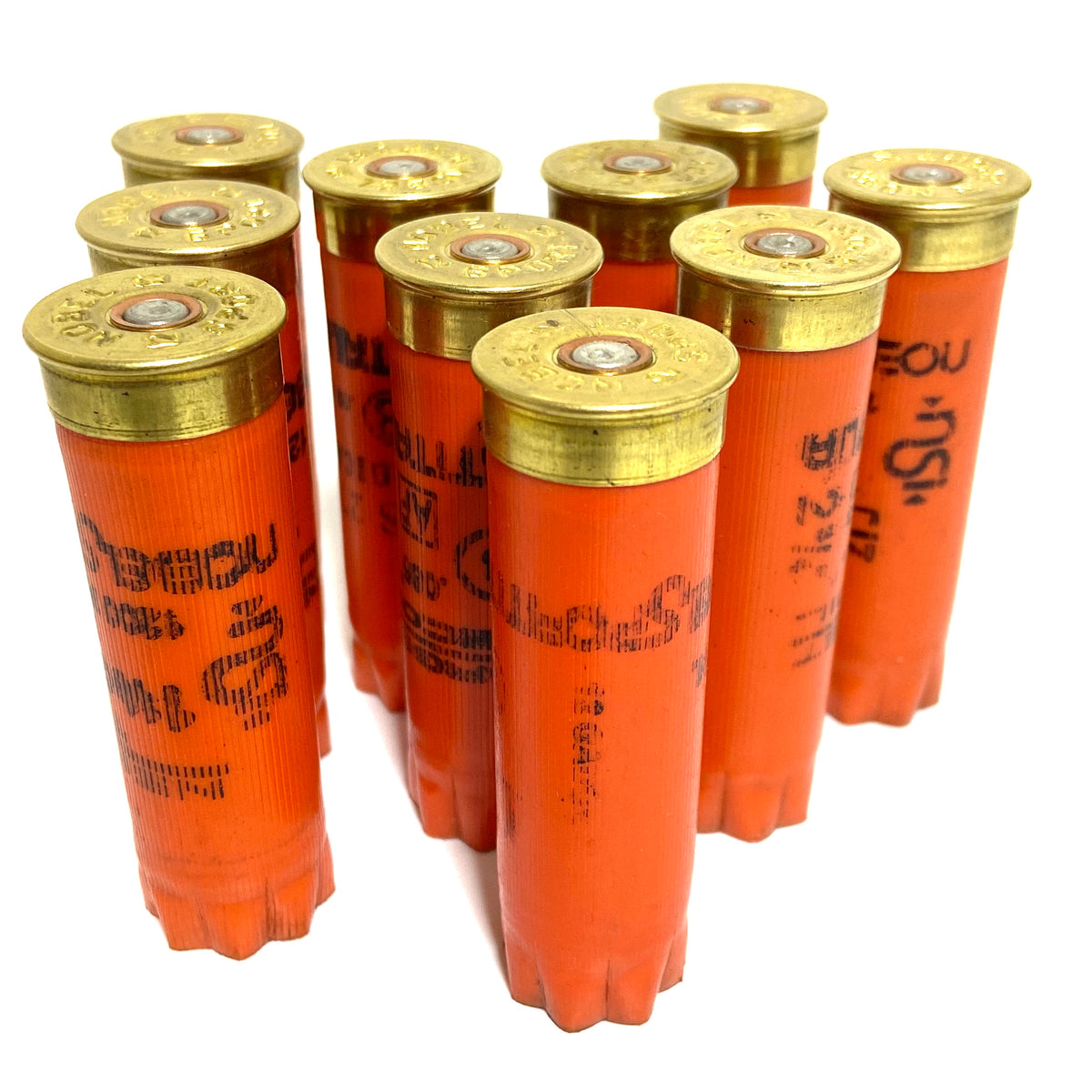 9 orange Nobel Sport shotgun shells standing upright with brass bases on a white background