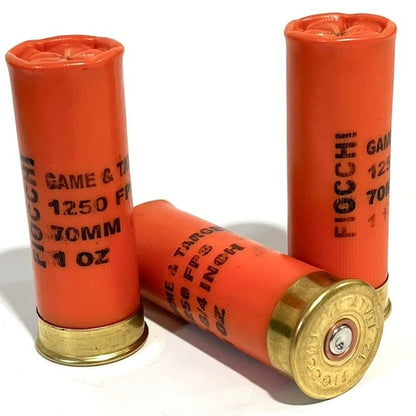 Three once-fired orange Fiocchi dummy rounds on white background, one showing gold headstamp base.