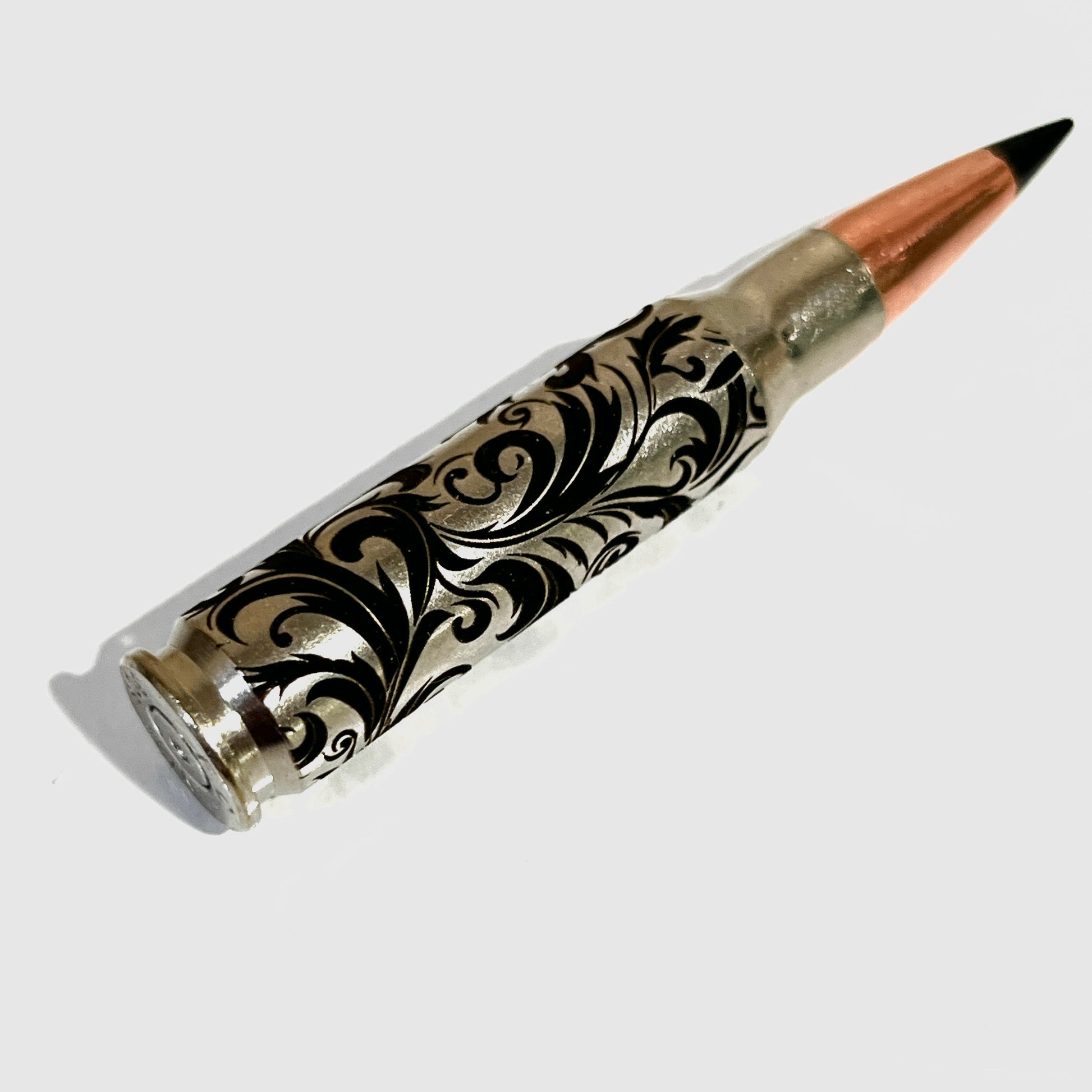 Baroque engraved bullet casings with black tips, designed as sophisticated, safe collector's items for display.