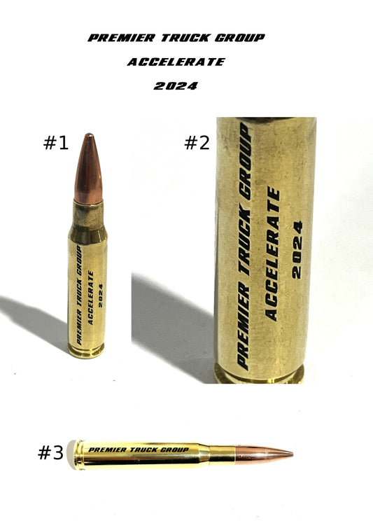 Design proof sheet showing three numbered views of a .50 BMG brass casing engraved with 'PREMIER TRUCK GROUP ACCELERATE 2024' text