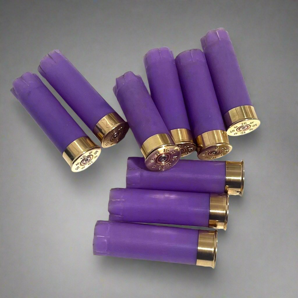 8 purple 16 gauge shotgun shell hulls with brass headstamps marked 16 on a gray background