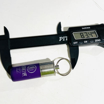 Digital caliper measuring 83.4 mm overall on a used purple cartridge keychain, from crimp end to split ring
