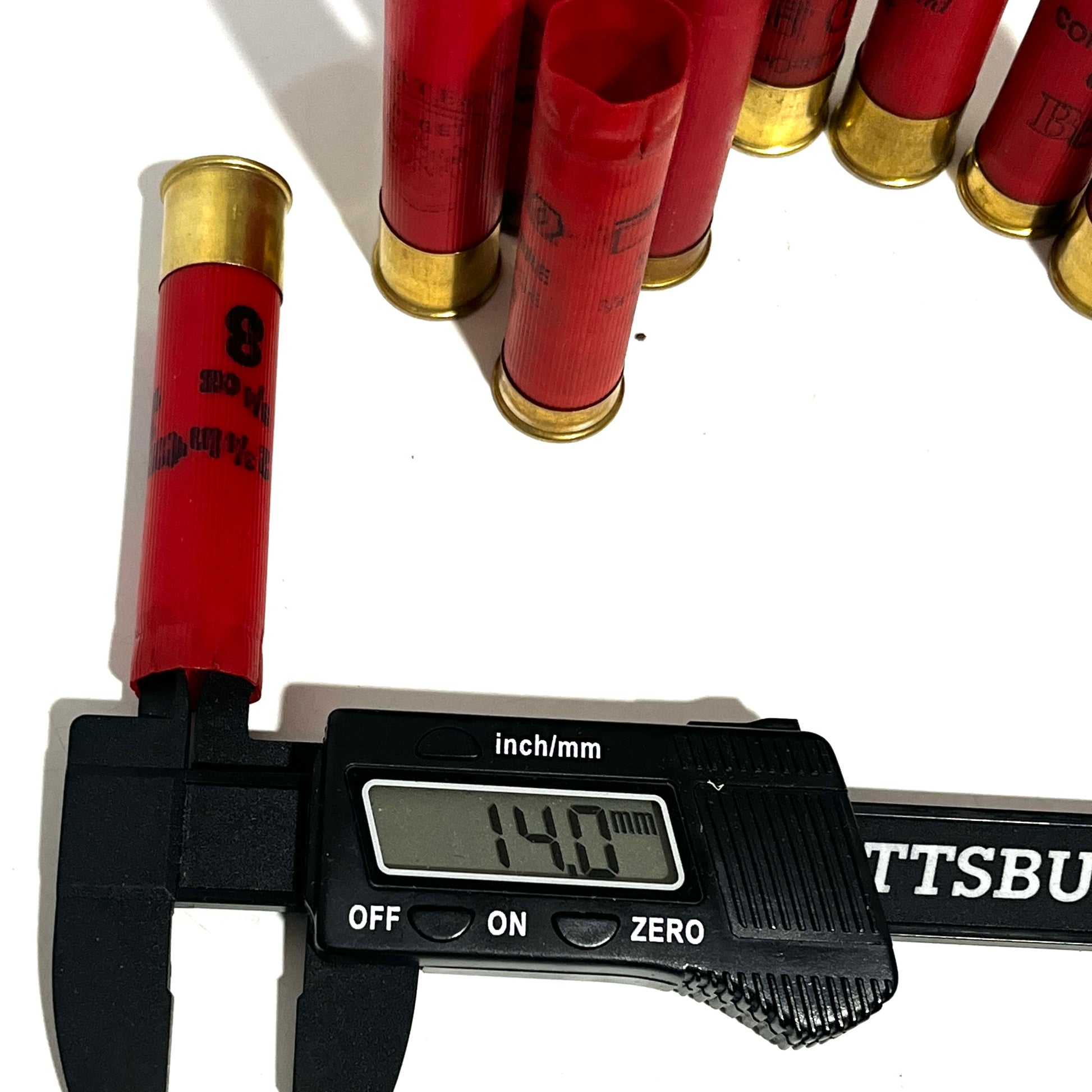 Digital caliper measuring the diameter of a red 28 gauge shotgun shell showing 14.0 mm