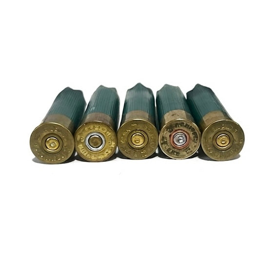 Close-up of five green 28 gauge empty shotgun hulls showing brass bases and spent primers on a white background.