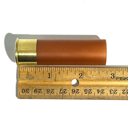 Rose gold 12 gauge blank shotgun shell measured against a ruler for DIY rustic wedding craft applications.
