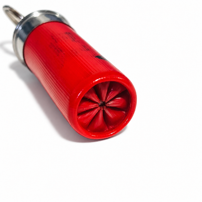 8 Star-crimp end of a red spent 12 gauge hull keychain, with the silver base and split ring behind it