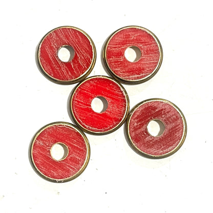 Five red shotgun shell slices with brass rims sit in a pinwheel pattern on white.