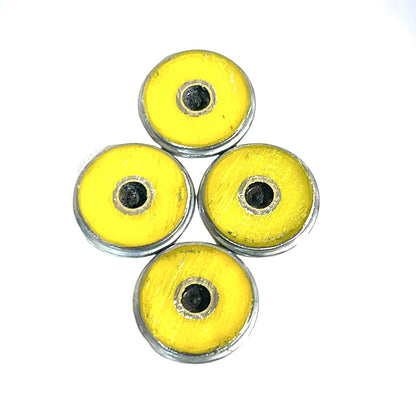 Four shotgun shell slices yellow on the underside on a white background