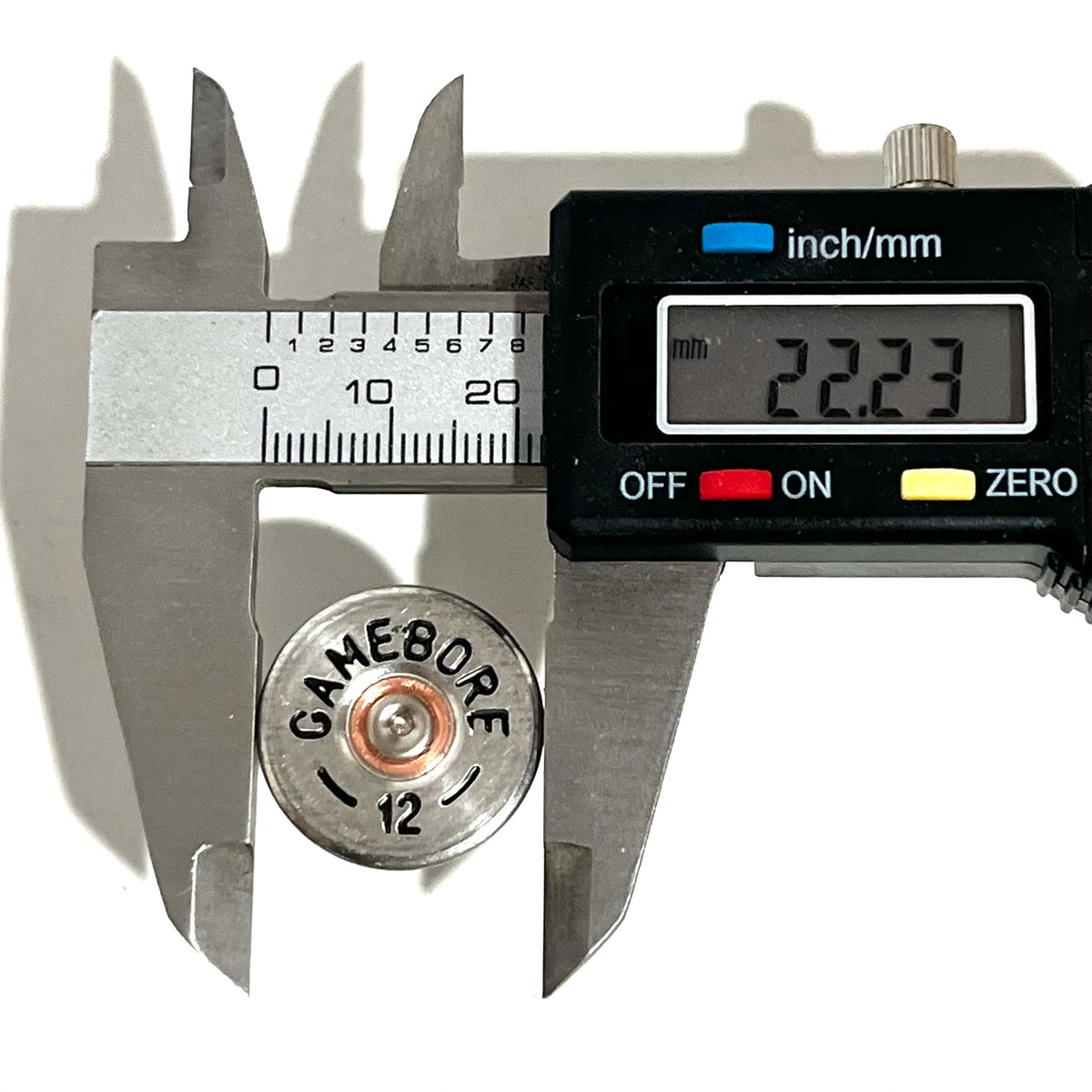 Digital caliper measuring the diameter of a silver Gamebore 12 gauge shotgun shell slice showing 22.23 mm