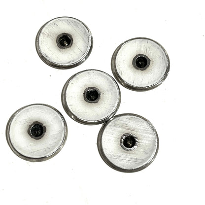 5 round shotgun shell slices viewed from the underside showing white enamel-lined centers